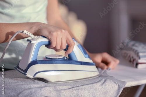 Woman ironing cloth on board, closeup