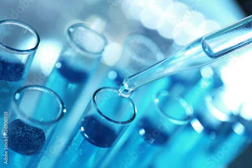 Pipette dropping sample into test tube, closeup