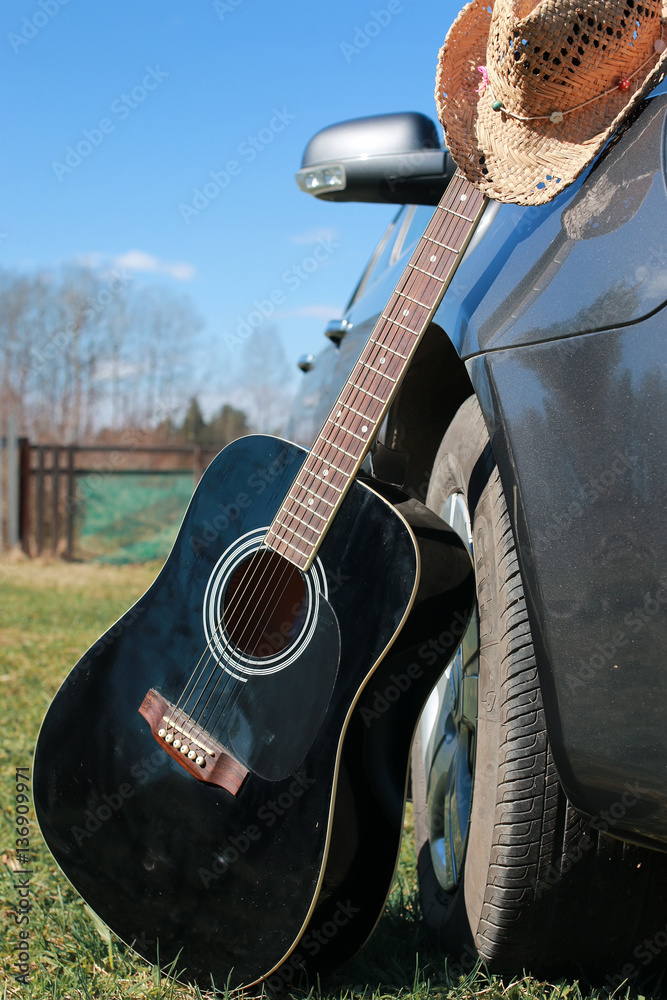 Fototapeta premium guitar outdoor near car
