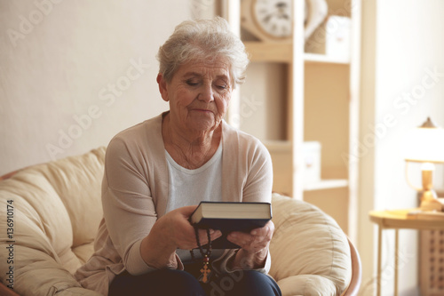 Elderly woman with Bible an...