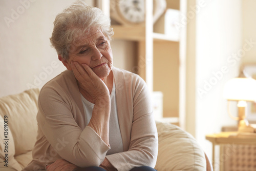 Depressed elderly woman sit...