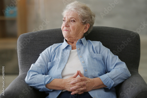 Depressed elderly woman sit...