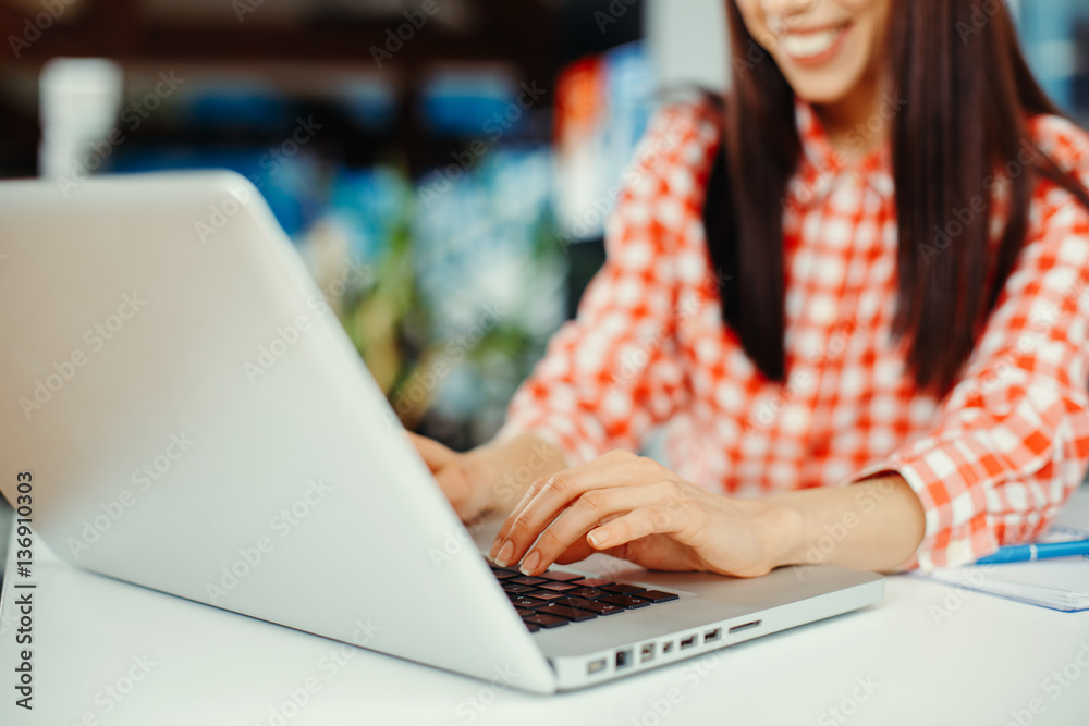 Young woman typing on laptop with a focus on hands Young woman typing on laptop with a focus on hands