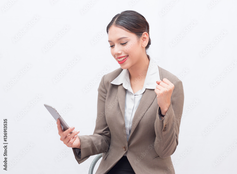 Businesswoman use of mobile phone. young woman used smart phone and tablet. business woman in the moment of success Businesswoman use of mobile phone. young woman used smart phone and tablet. business woman in the moment of success