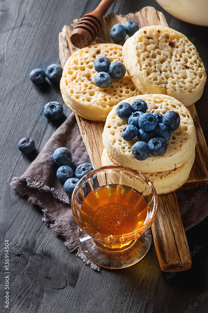 Hot Home made toasted crumpets served with honey, blueberry. Dar