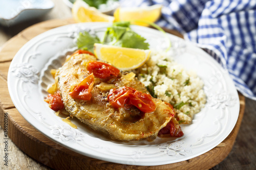 Trout, cooked with smoked paprika, tomatoes and couscous