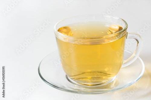 Glass cup with green tea on white background.