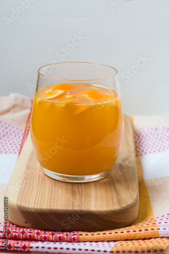 Fresh orange juice on wooden board. Country style photo