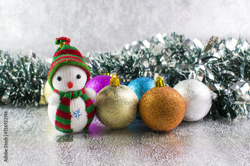 Christmas balls and snowman on a silver background photo