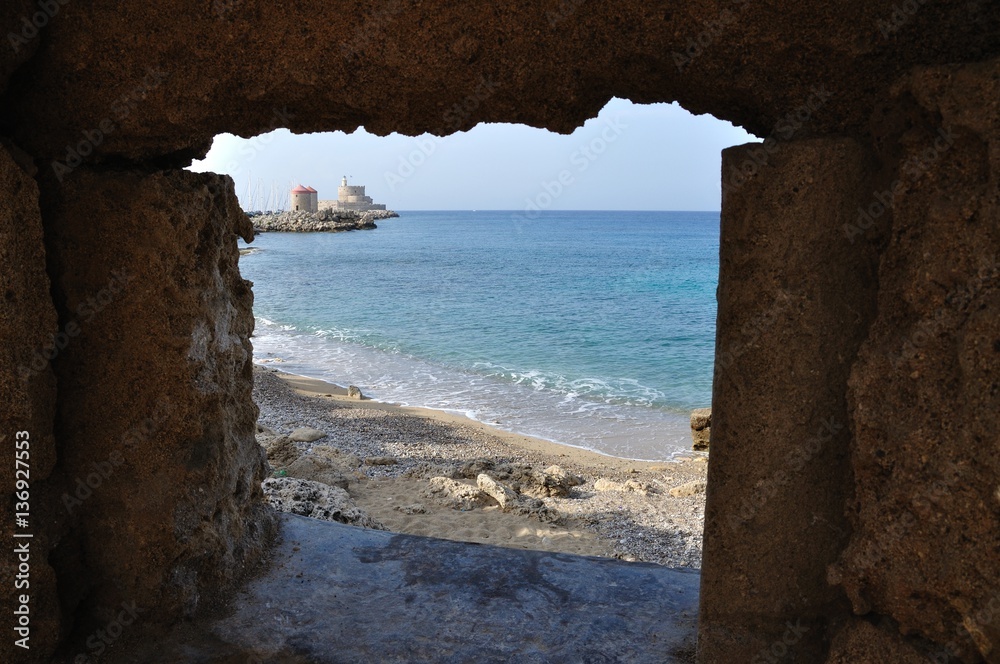 The Medieval Mills from Rhodos as Seen Through a Breach in the Wall