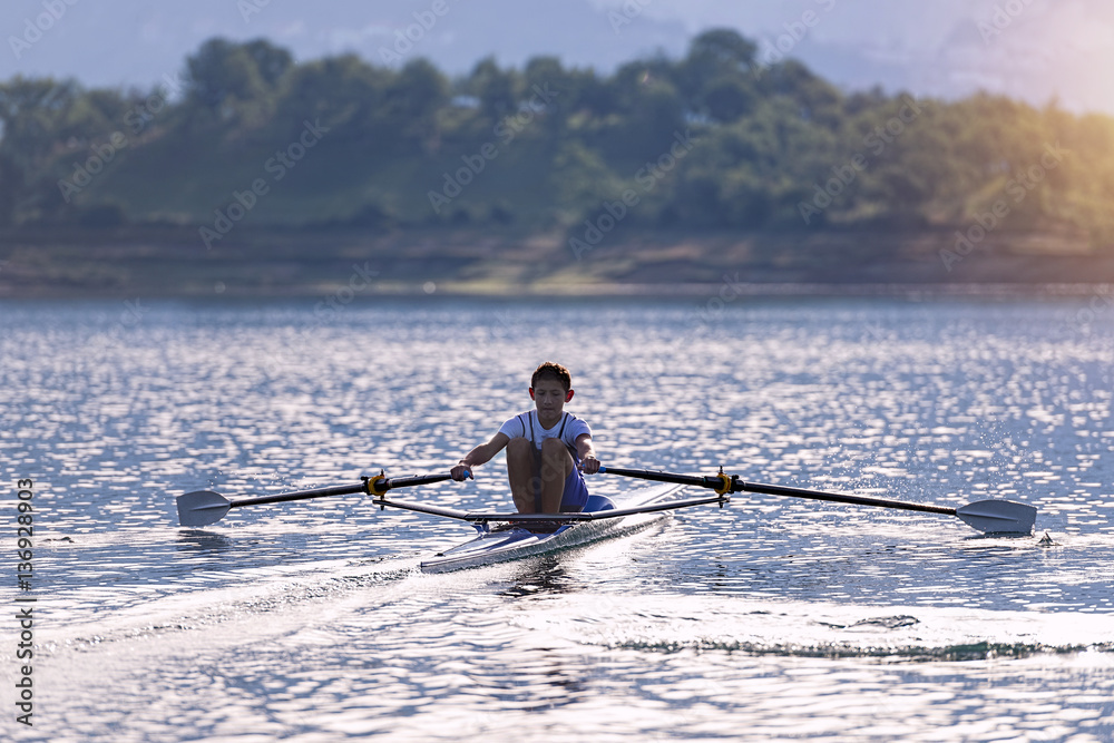 Child in the course of rowing on single Child in the course of rowing on single