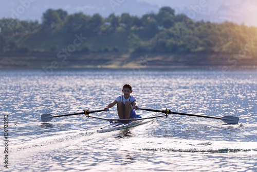 Child in the course of rowing on single