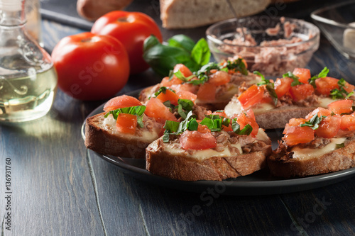 Appetizer bruschetta with tuna, mozarella cheese and tomatoes