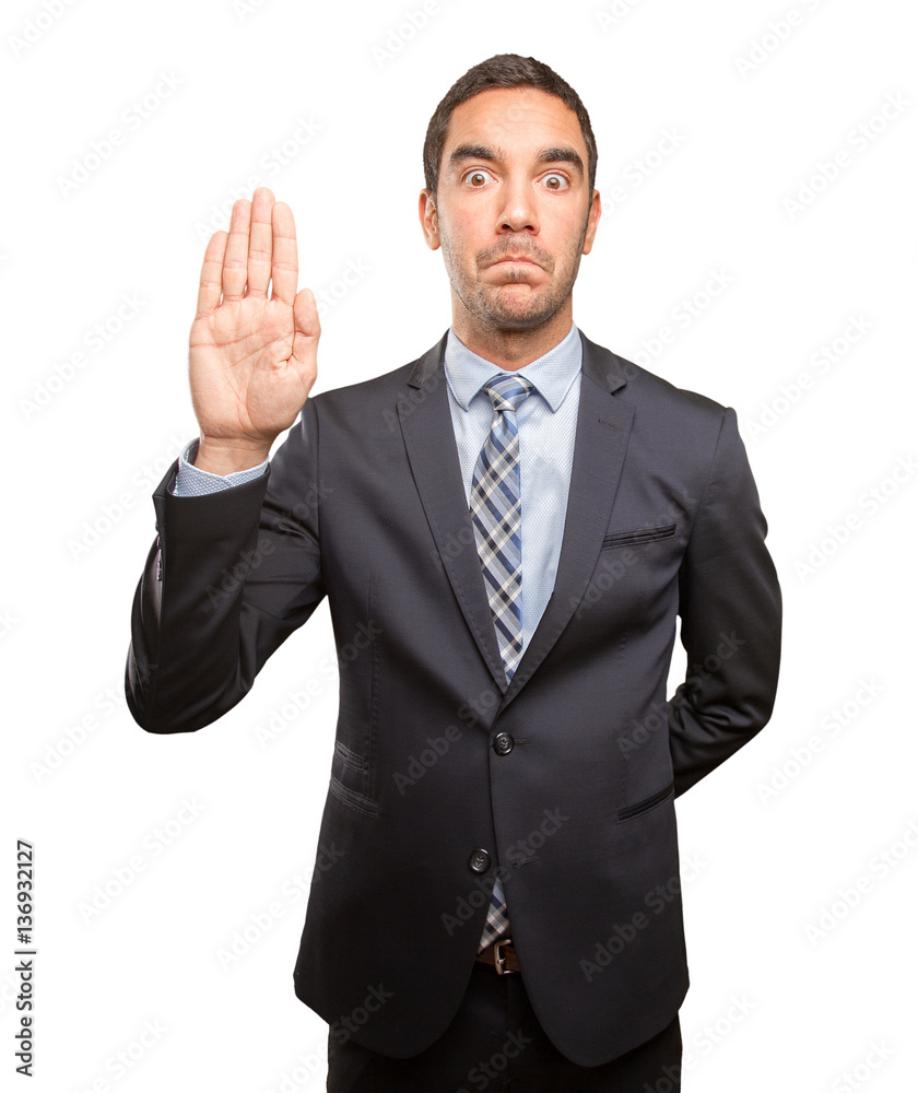 Serious young man doing a stop gesture Serious young man doing a stop gesture