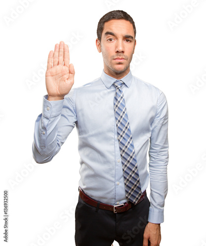 Serious young man doing a stop gesture