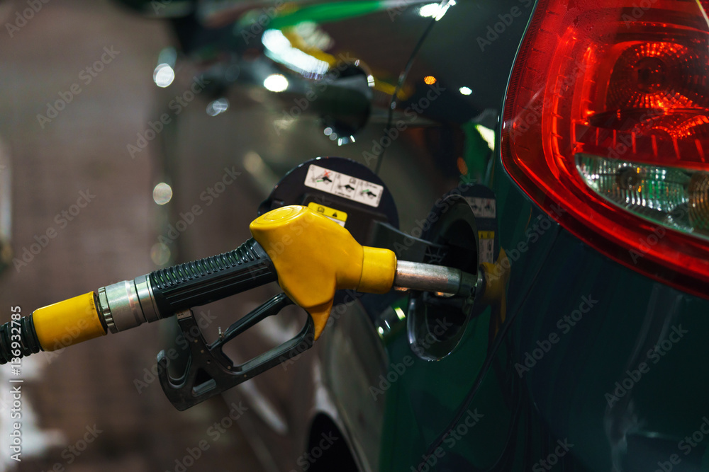 Car refueling on a petrol station in winter at night