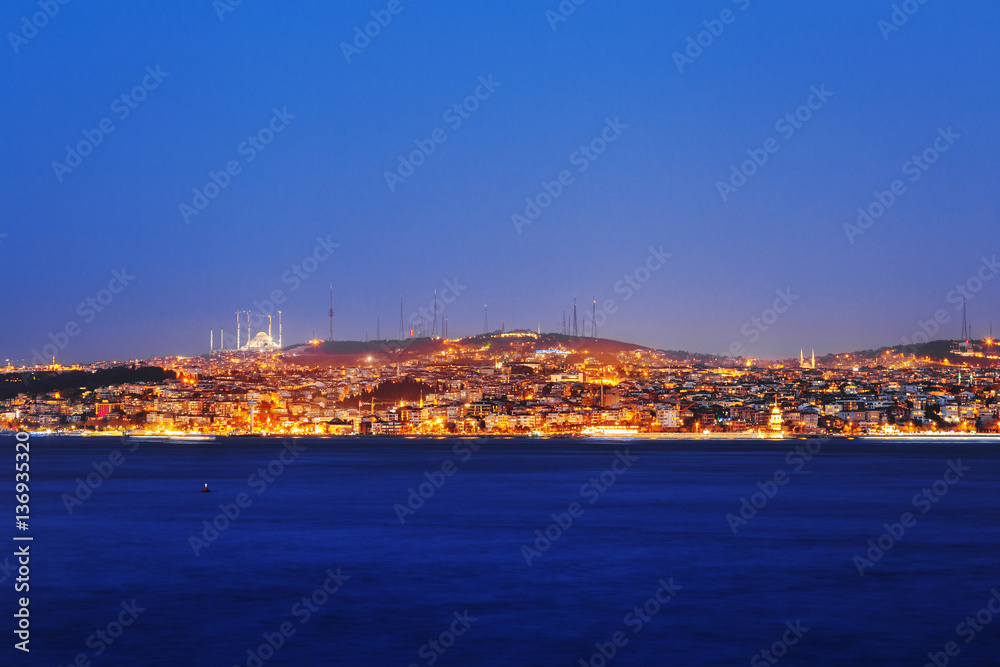 Istanbul classical night skyline scenery, view over Bosporus channel. Blue sky and blue water of Bosporus channel.