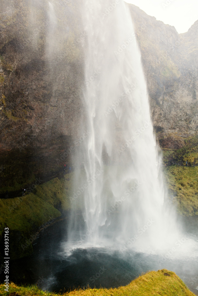 Rapid waterfall flowing into small river Rapid waterfall flowing into small river
