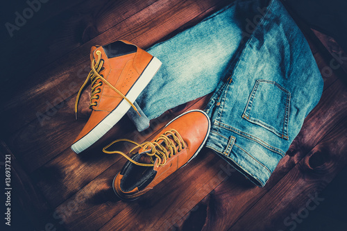 Men's Clothing yellow running shoes on a wooden background