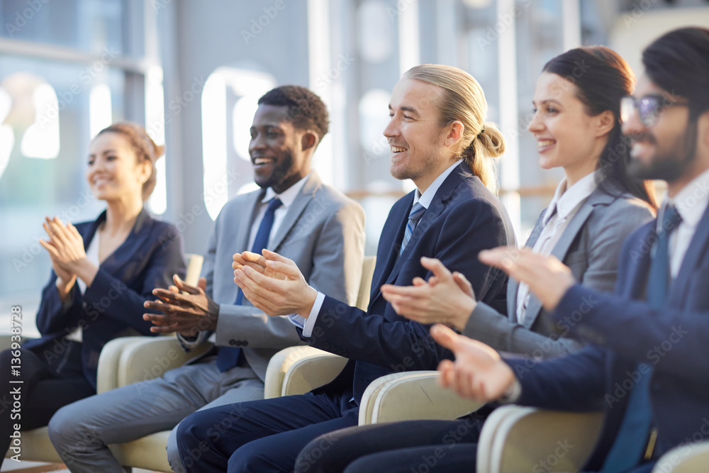 Row of business people clapping hands after report of speaker Row of business people clapping hands after report of speaker