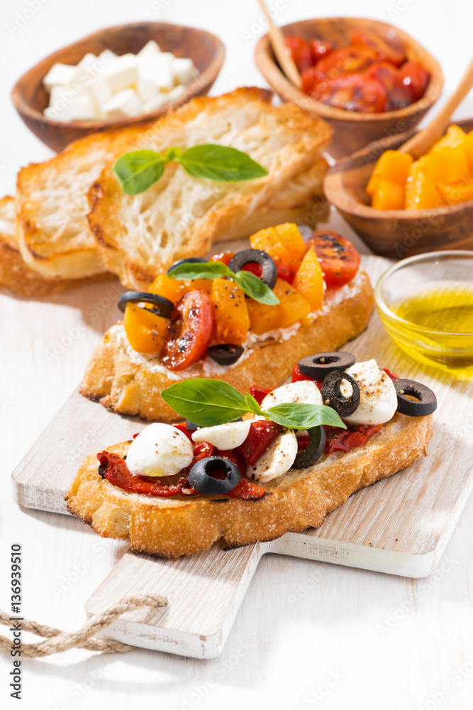 bruschettas with tomatoes and mozzarella on wooden board