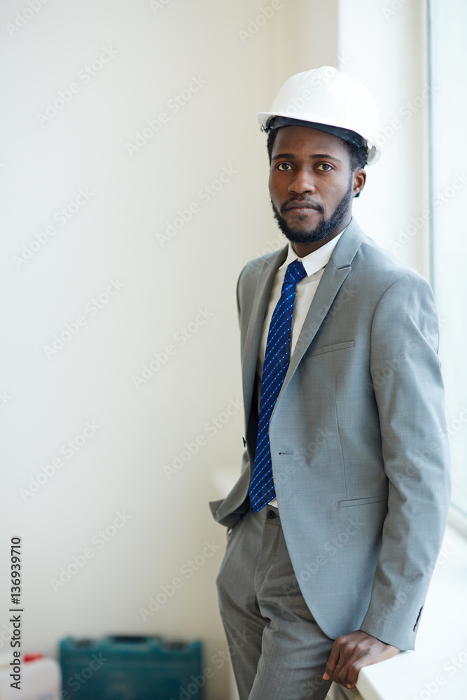 Young foreman standing by window and looking at camera Young foreman standing by window and looking at camera