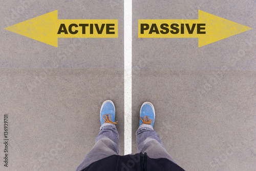 Active vs Passive text arrows on asphalt ground, feet and shoes