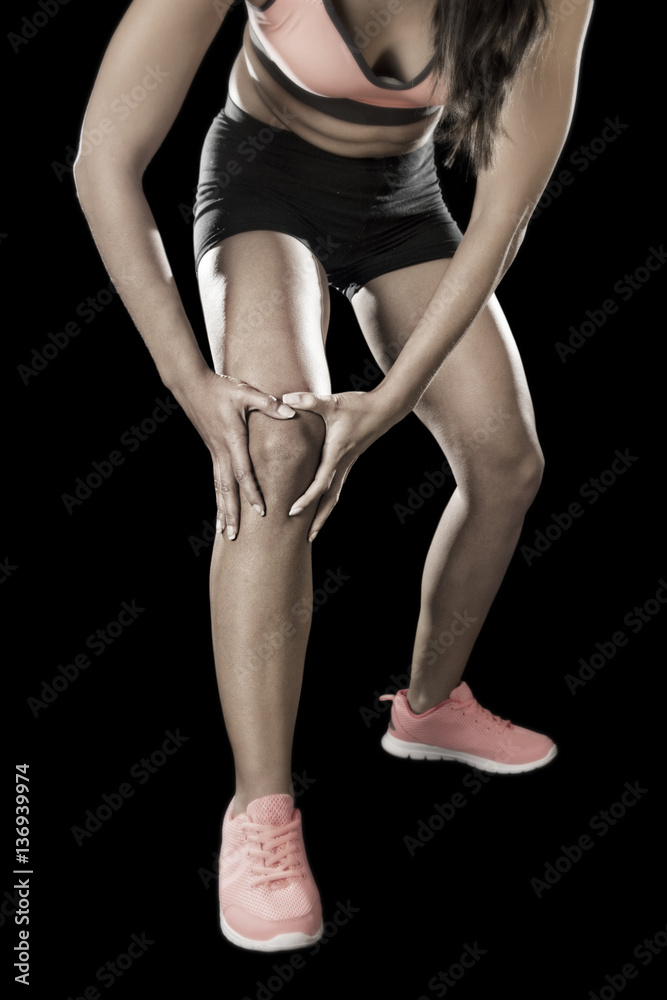 young sport woman holding injured knee suffering pain in ligamen young sport woman holding injured knee suffering pain in ligamen
