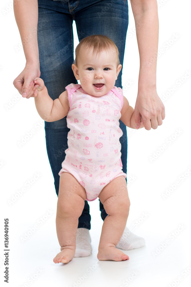 little baby boy doing first steps with mother support little baby boy doing first steps with mother support
