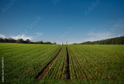 Couple in love walking along the field © myronovychoksana