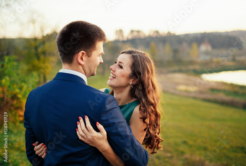 Couple in love embracing near lake