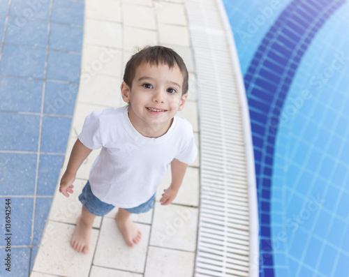 3 years old boy on resort pool enjoying