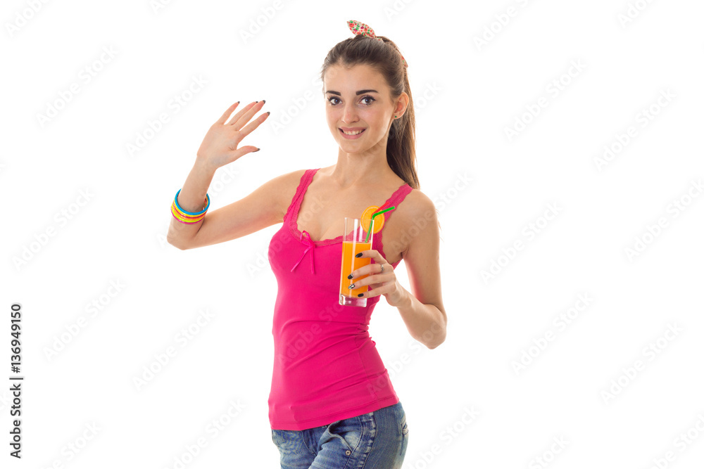 cutie young brunette girl in light summer clothes with orange cocktail in her hands looking at the camera and smiling isolated on white background cutie young brunette girl in light summer clothes with orange cocktail in her hands looking at the camera and smiling isolated on white background