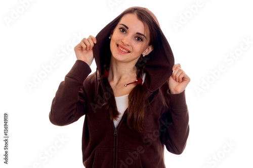 young beautiful student woman in brown sports clothes with hood smiling on camera isolated on white background