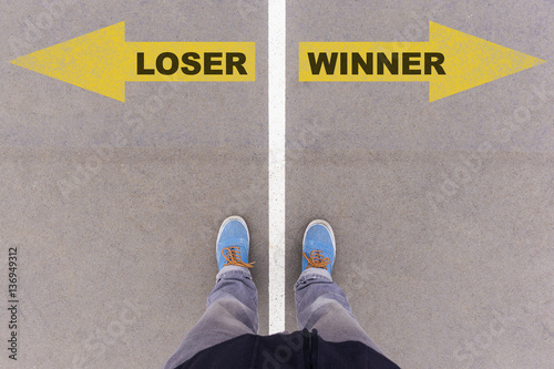Loser vs Winner text arrows on asphalt ground, feet and shoes on