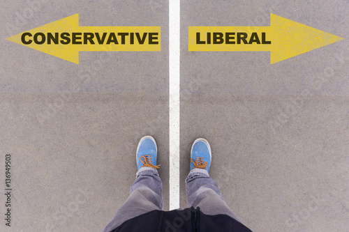 Conservative vs Liberal text arrows on asphalt ground, feet and photo