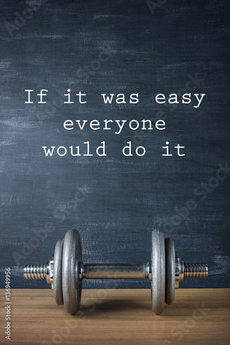 Photo metal barbell on dark gray background and motivation text