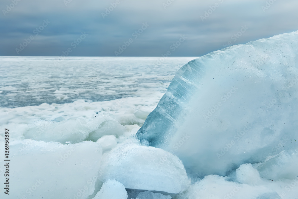 chunks of ice washed ashore. in the background frozen winter sea. prekrany winter view.
chunks of ice washed ashore. in the background frozen winter sea. prekrany winter view.