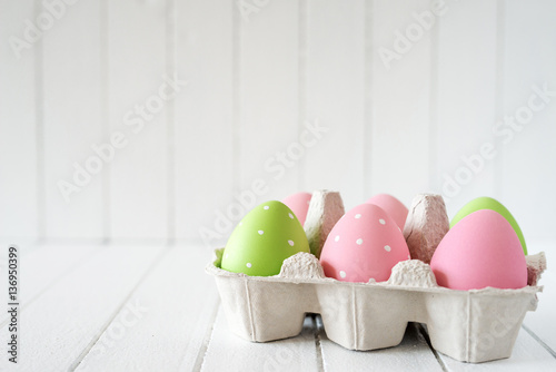 Easter eggs over white striped background - copy space