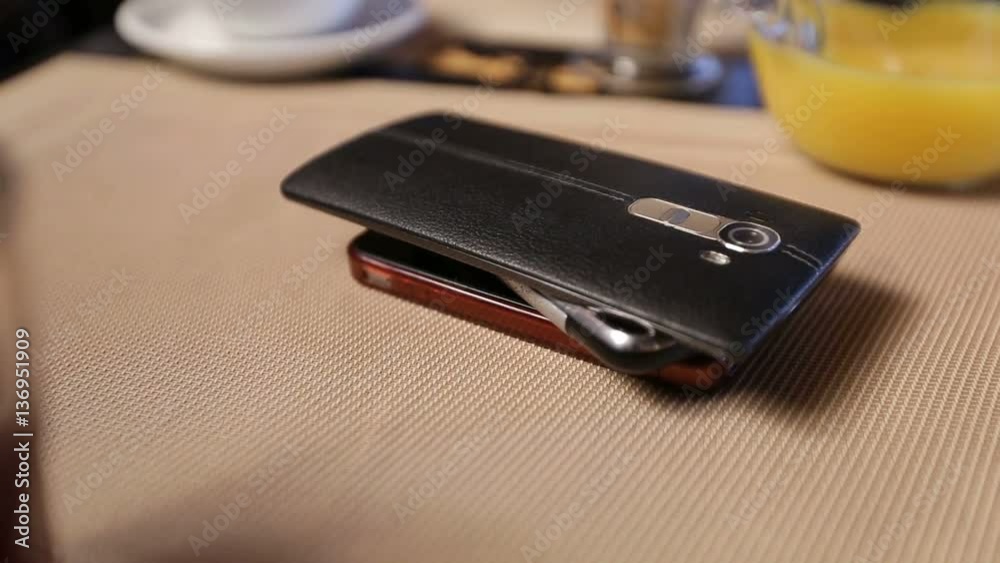 Pile of mobile phones on the table in cafe.