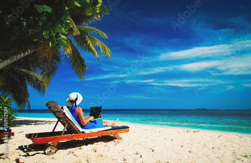 remote work concept -young woman with laptop on beach © nadezhda1906