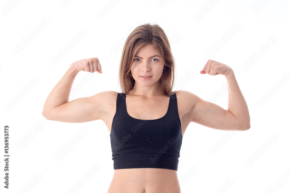 athletic girl in black top shows muscle on hand isolated white background athletic girl in black top shows muscle on hand isolated white background
