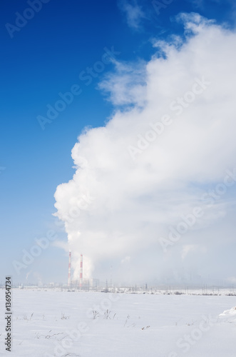 Winter landscape with industrial facility