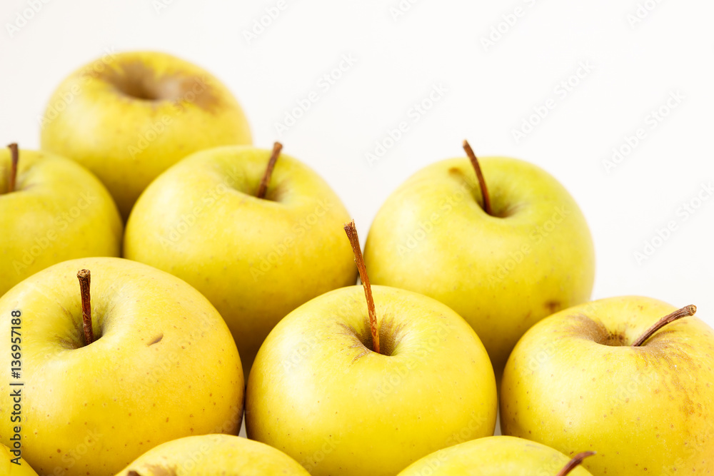 Golden delicious apples on light beige background with copy space Golden delicious apples on light beige background with copy space
