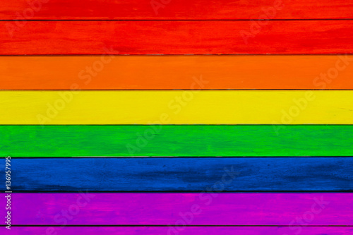 Trims in rainbow colors. Colorful wooden background. gay flag.