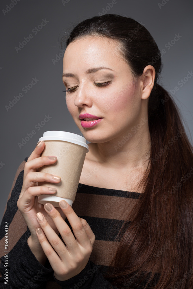 woman with a paper cup of coffee woman with a paper cup of coffee