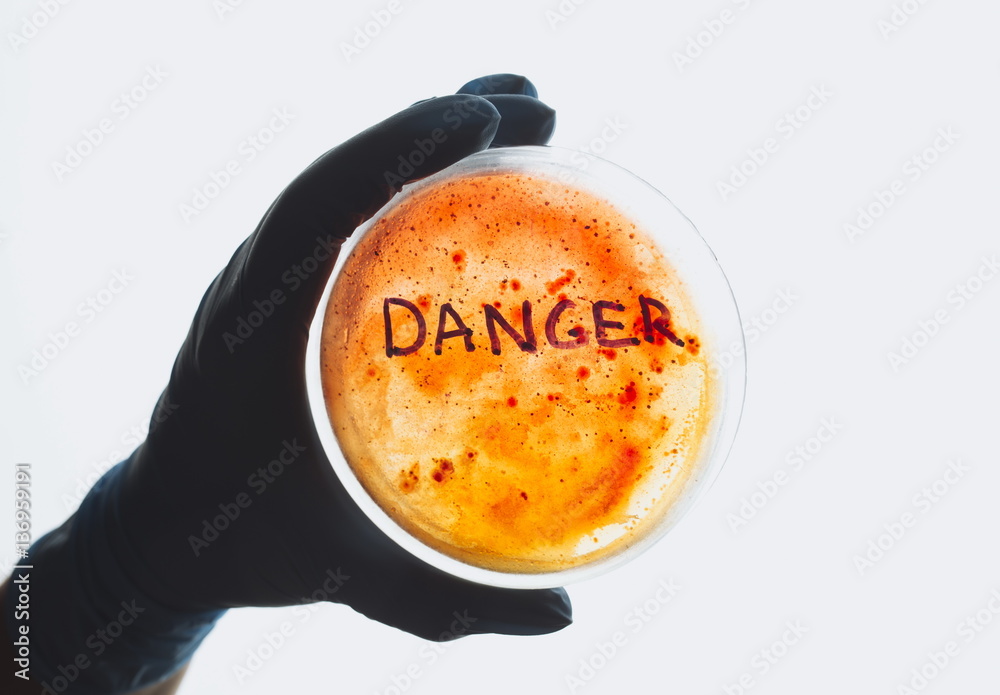 Word danger on Petri dish with bacterial infection test sample. Medical