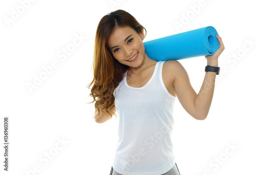 Young woman holding a yoga mat on white background