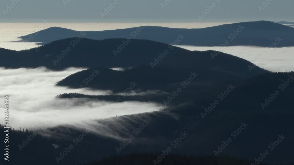 Early morning fog rolling over mountainous landscape in the vast forests of the Pacific Northwest, Oregon. Early morning fog rolling over mountainous landscape in the vast forests of the Pacific Northwest, Oregon.