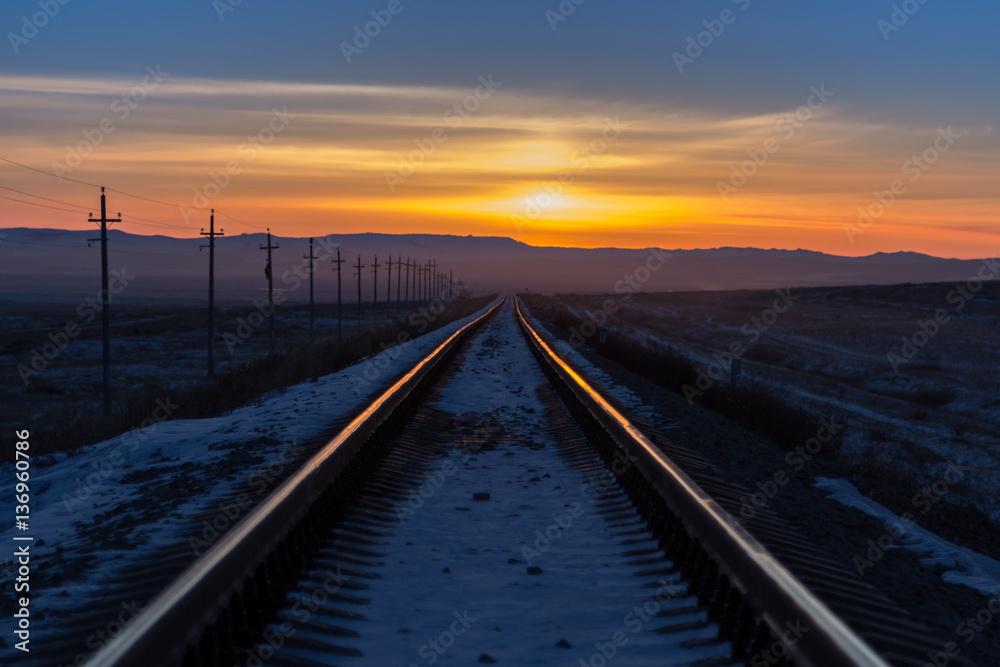 Railway receding into the distance at sunrise
